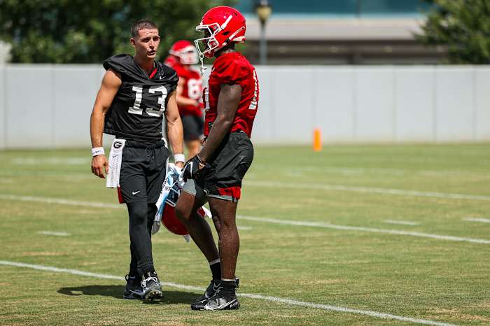 Stetson Bennett and Kearis Jackson talk strategy at practice. 